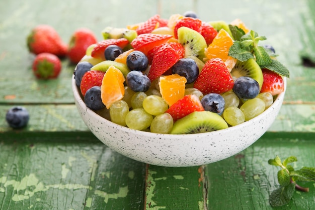 Fresh fruit salad, blueberries, strawberries, grapes, kiwi, orange. Selective focus