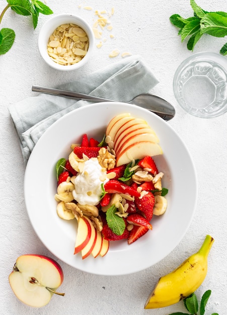 Fresh fruit salad top view. Healthy food plate copy space