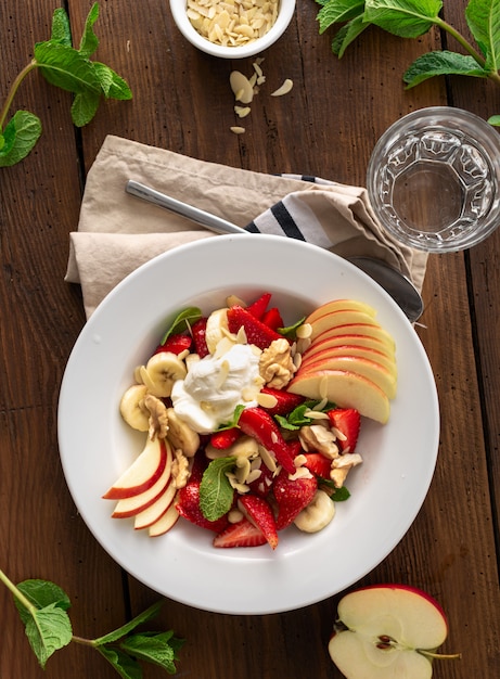 Fresh fruit salad top view. Healthy food plate copy space