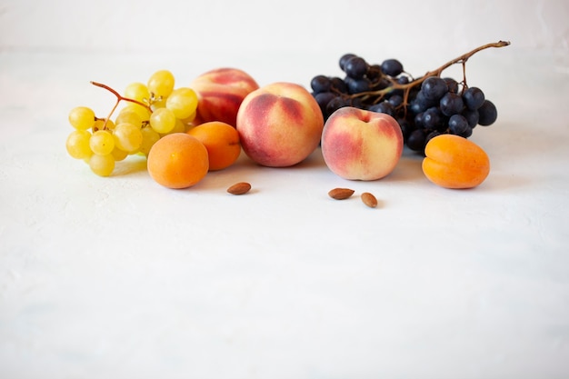 Fresh fruits and almonds on the white background, health food concept, white background, side view, copy space, banner