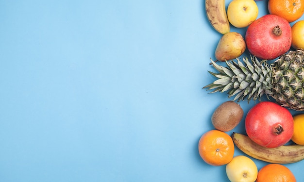 Fresh fruits on a blue wall