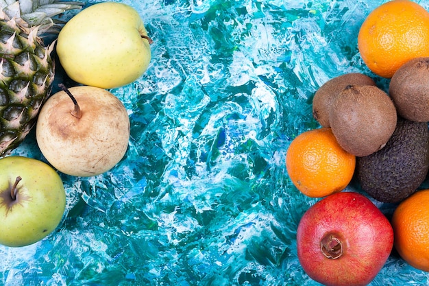 Fresh fruits on colorful vivid wooden background