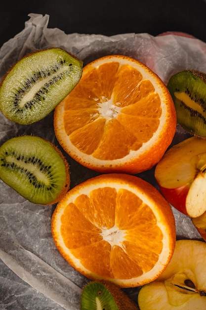 Fresh fruits on a dark background Orange and kiwi in a cut isolated on a black background Copy space high resolution product