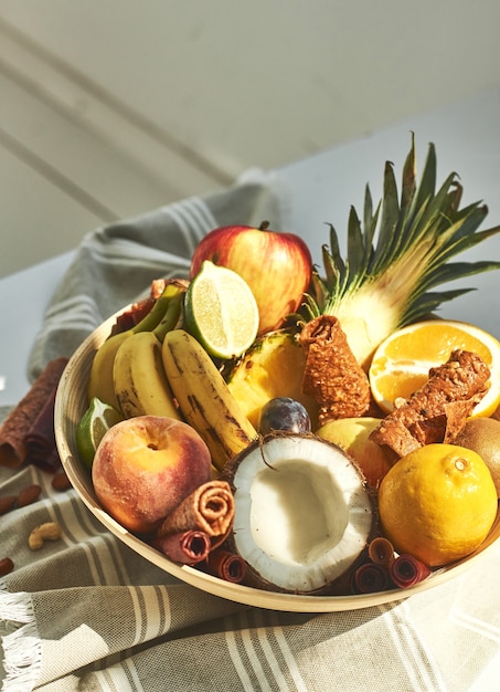 Fresh fruits in a plate on the table.