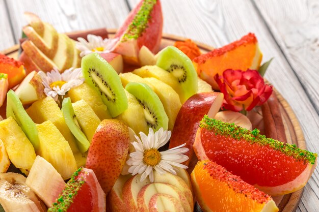 Fresh fruits in plate on wooden table