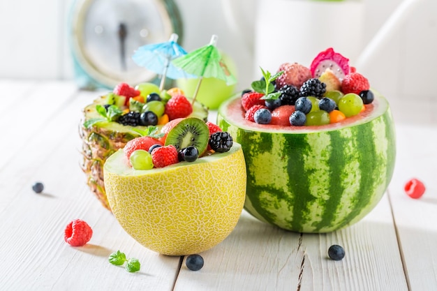 Fresh fruits salad in pineapple and melon with berry fruits