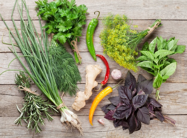 Fresh garden herbs and spices on wooden table. Top view