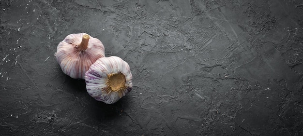 Fresh garlic on a dark background Vegetables Top view Free space for your text