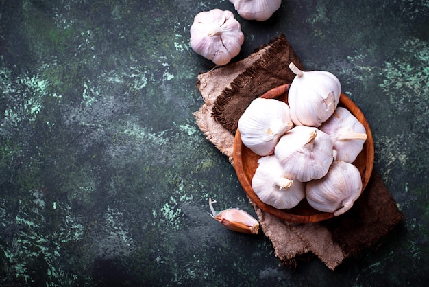 Fresh garlic on green background