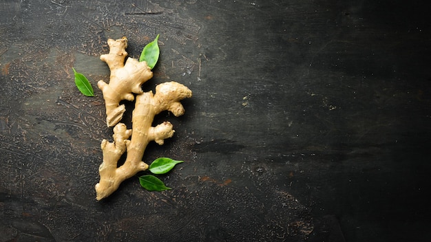 Fresh ginger root on stone background Vitamins Top view Free space for your text