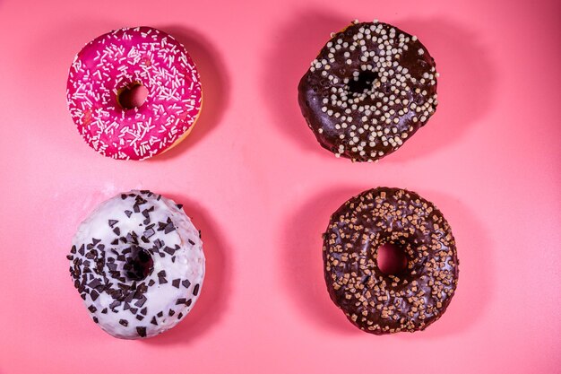 Fresh glazed donuts isolated on a pink background