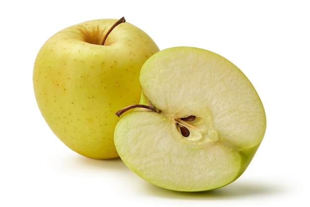 The fresh Golden Delicious apples are isolated on a white background. A whole apple and half.