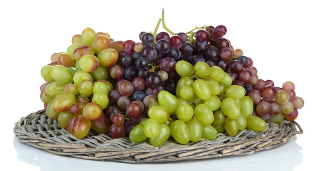 Fresh grape on wicker mat isolated on white