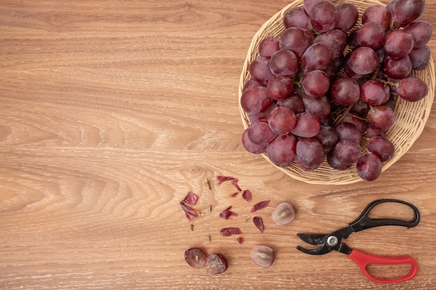 Fresh grapes on basket wood background. copy space for add text. 