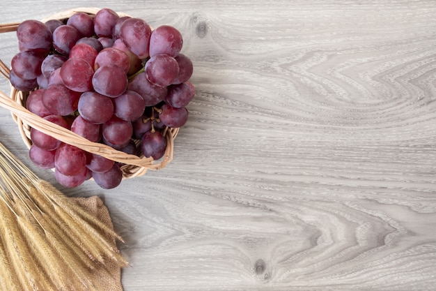 Fresh grapes on basket wood background. copy space for add text. 