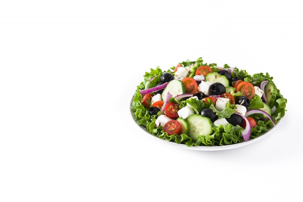 Fresh Greek salad in Plate with black olive,tomato,feta cheese, cucumber on white