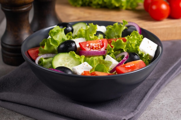 Fresh Greek salad with delicious rucola, spinach, arugula, feta cheese, cucumber, red onion and cher