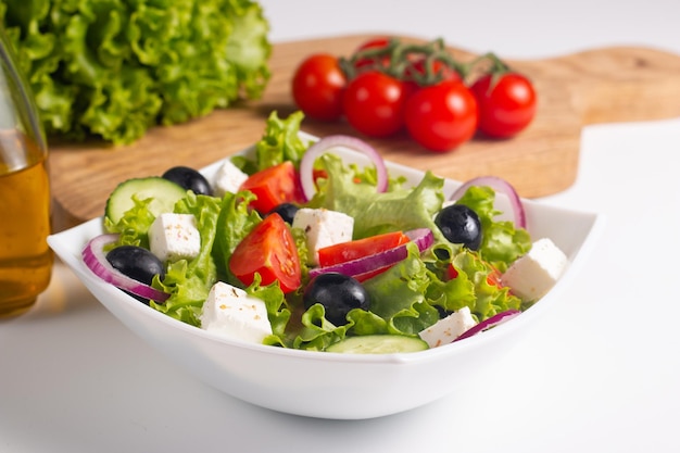 Fresh Greek salad with delicious rucola, spinach, arugula, feta cheese, cucumber, red onion and cher