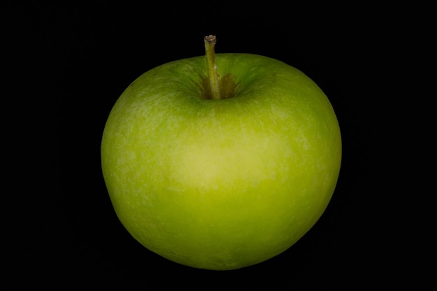 Fresh green apple and sliced isolated on black background art abstract concept