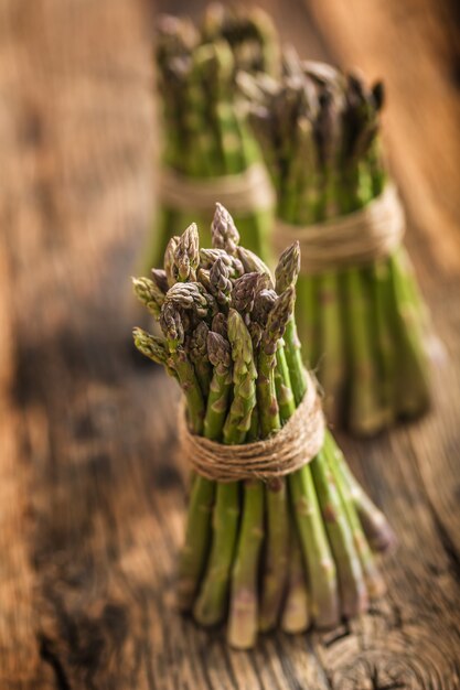 Fresh green asparagus on old oak table.