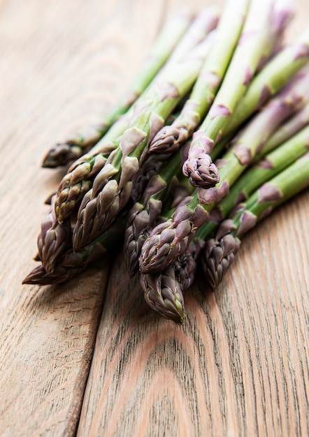 Fresh green asparagus on old wooden table