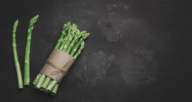 Fresh green asparagus sprouts on a black background View from above