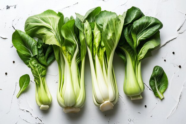 Fresh green bok choy on white stone background top view