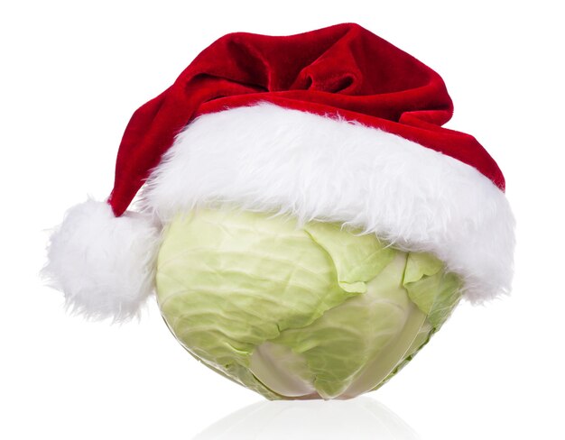 Fresh green cabbage vegetable with Santa hat on white background