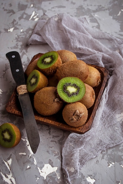 Fresh green kiwi in wooden bowl