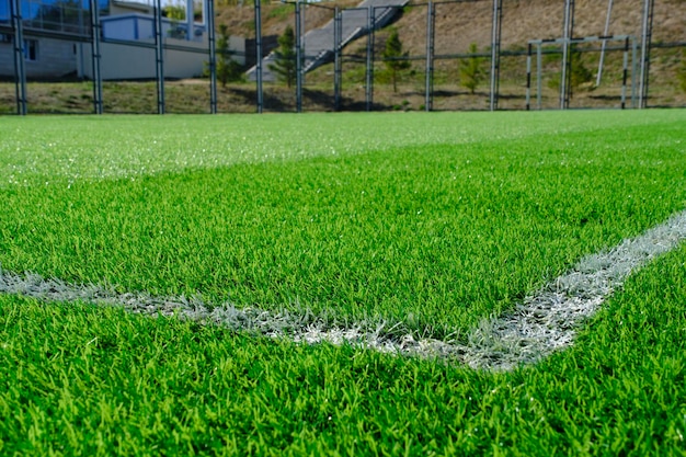 Fresh green lawn with markings on football field