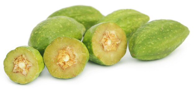 Fresh green medicinal haritaki fruits  over white background