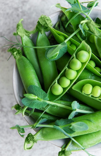 Fresh green pea pods and green peas