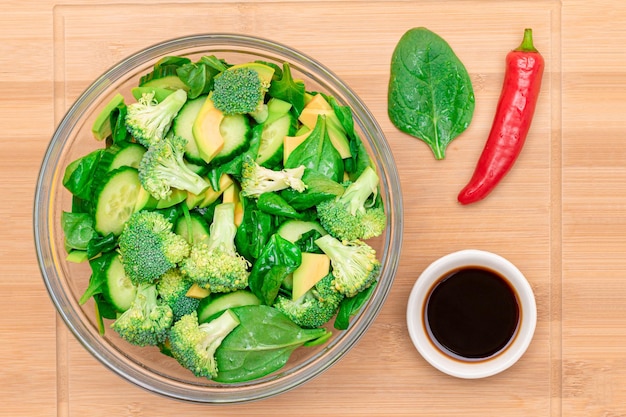 Fresh green salad of avocado broccoli spinach and cucumber