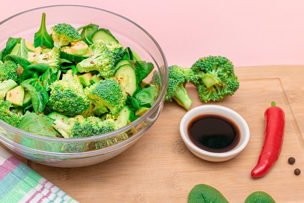 Fresh green salad of avocado broccoli spinach and cucumber