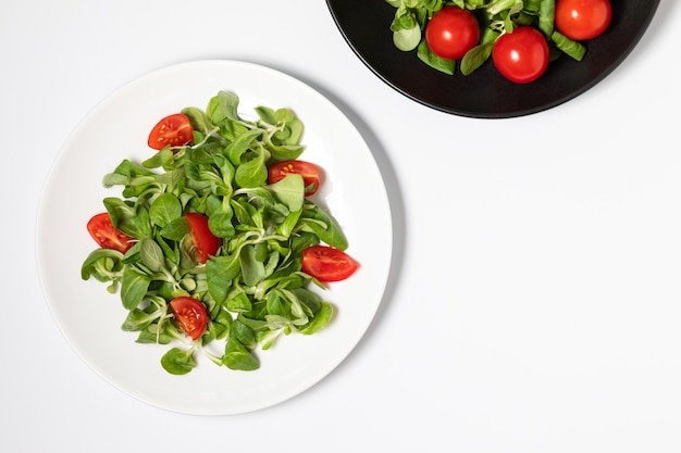 Fresh green salad isolated on white background, flat lay.