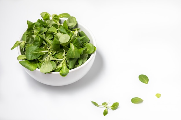 Fresh green salad isolated on white background, flat lay.