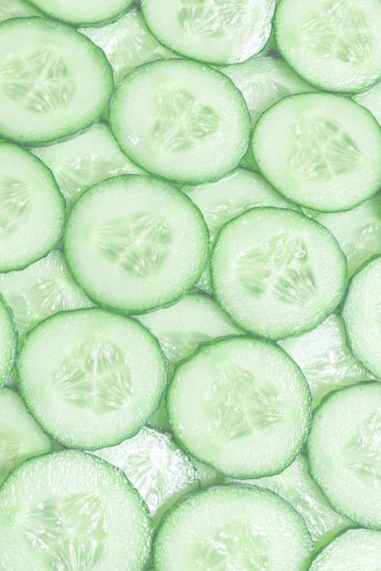 Fresh green slices of cucumber as background