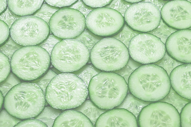 Fresh green slices of cucumber as background