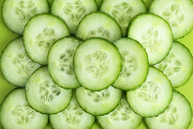 Photo fresh green slices of cucumber as background