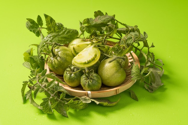 Fresh green tomatoes on a solid background