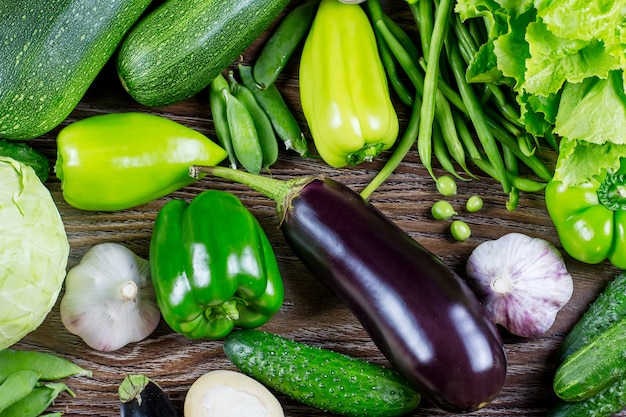 Fresh green vegetables, autumn harvest on a wooden background