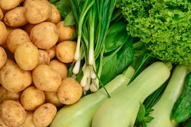 Fresh green vegetables and herbs as a background