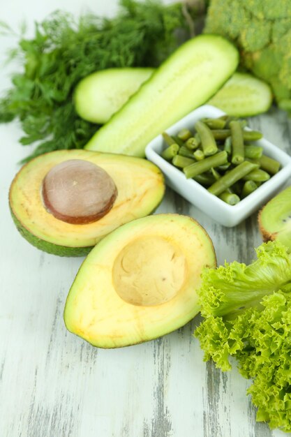 Fresh green vegetables on wooden background