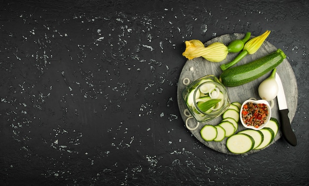 Fresh green zucchini on a dark table. The view from the top. Copy space.