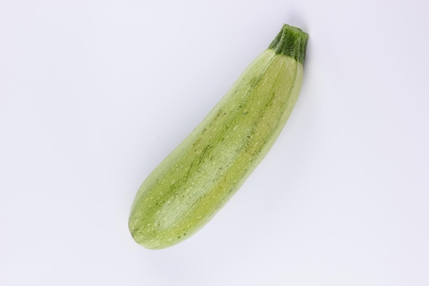 Fresh green zucchini isolated on white background Closeup of a green vegetable Healthy food concept