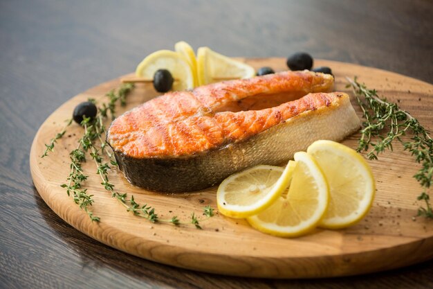 Fresh grilled salmon steak on a wooden board