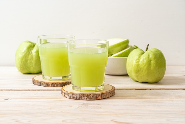 fresh guava juice glass with fresh guava fruit on wood table