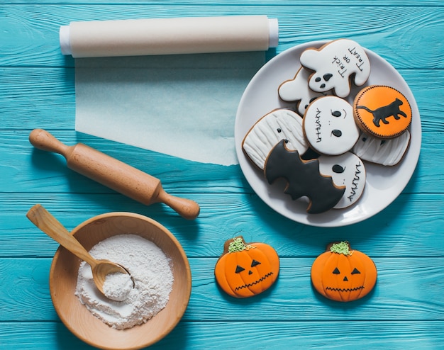 Photo fresh halloween gingerbread cookies on blue wooden table.