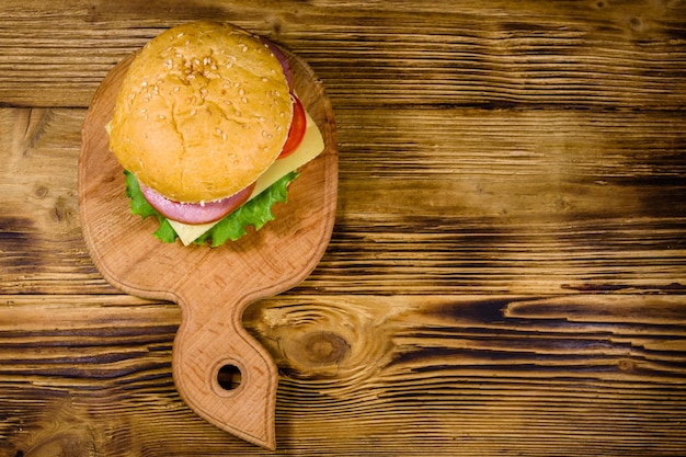 Fresh hamburger on a wooden cutting board Top view