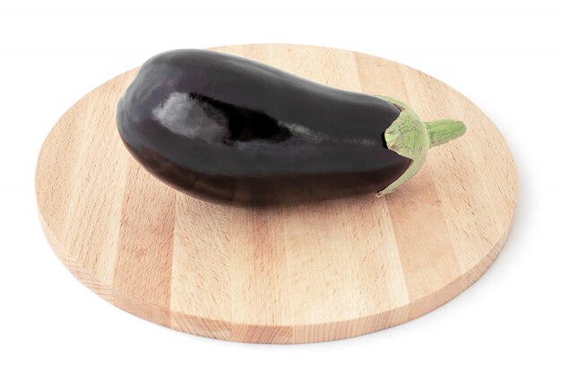 Fresh healthy eggplant on a wooden board